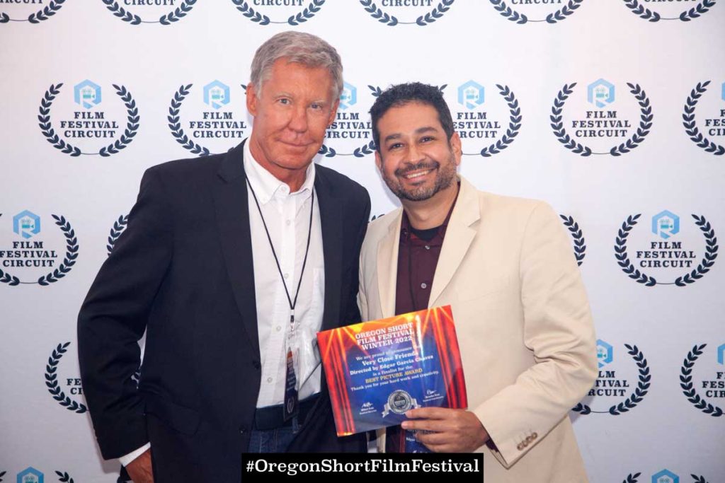 Actor Kent Shocknek and Director Edgar Garcia Chavez holding an award from the Oregon Short Film Festival
