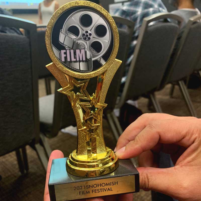 Snohomish Film Festival, and Director Edgar Garcia Chavez holding an award